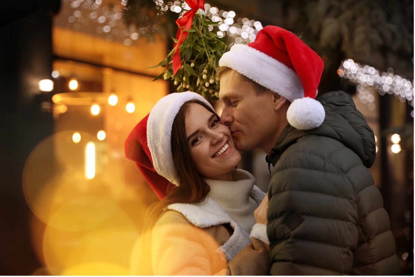 Man and Woman hugging wearing Santa Claus Hats