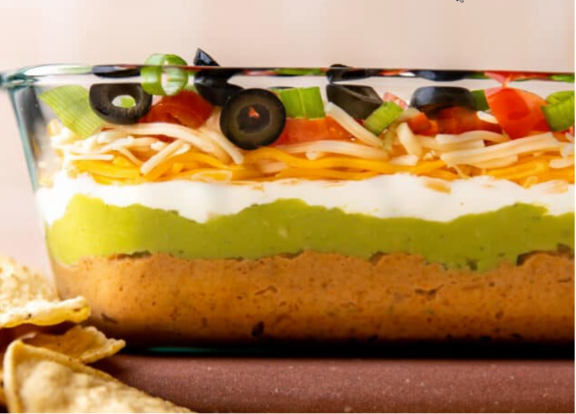 A picture containing a bowl of seven-layered dip