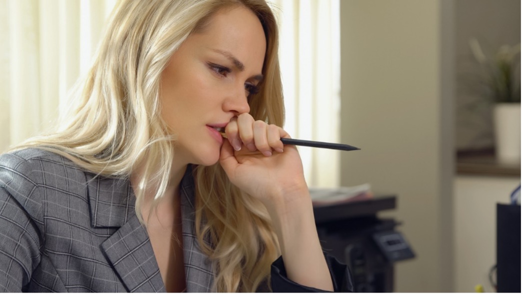 Person looking worried chewing on a pen,Daily Habits That Could be Wrecking Your Teeth