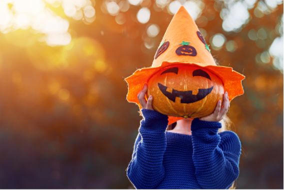 A child holding a pumpkin, October Smiles: Embracing Halloween and Your Smile with Cobb Orthodontics
