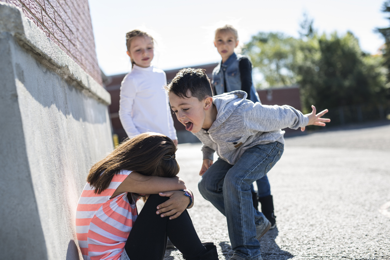 A group of children outside, one child bullying another, Helping Your Child Smile Confidently: Supporting National Bullying Prevention Month