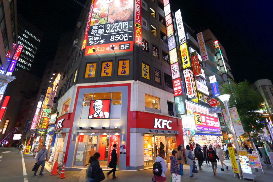 A group of people walking in a city at night