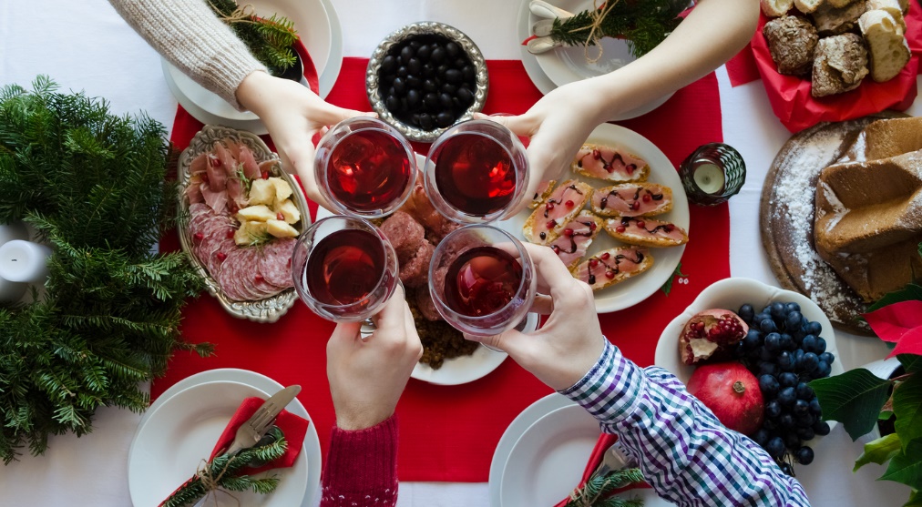 A group of people holding wine glasses 