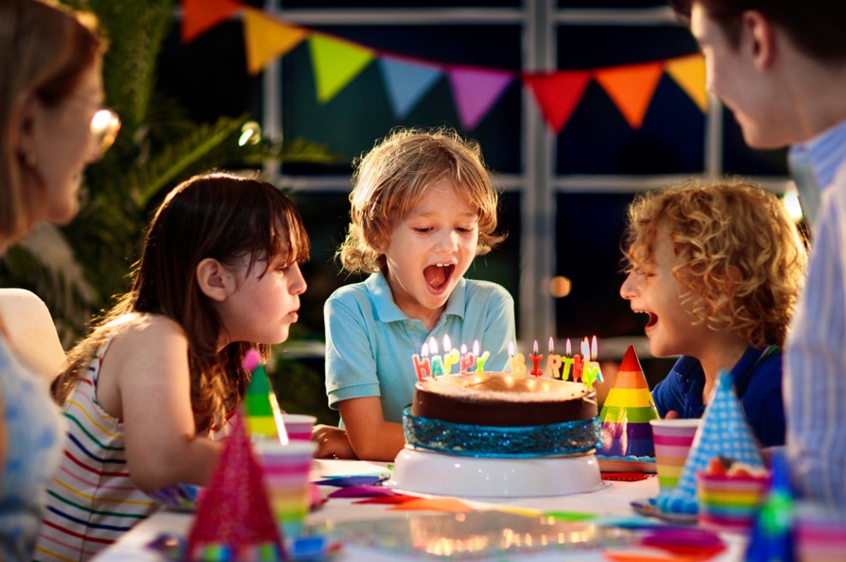 A group of kids around a birthday cake, Spacing for Incoming Teeth