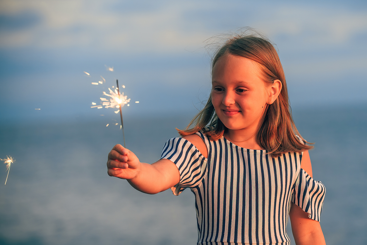 Smiles at 7 Day, A happy girl holding a sparkler