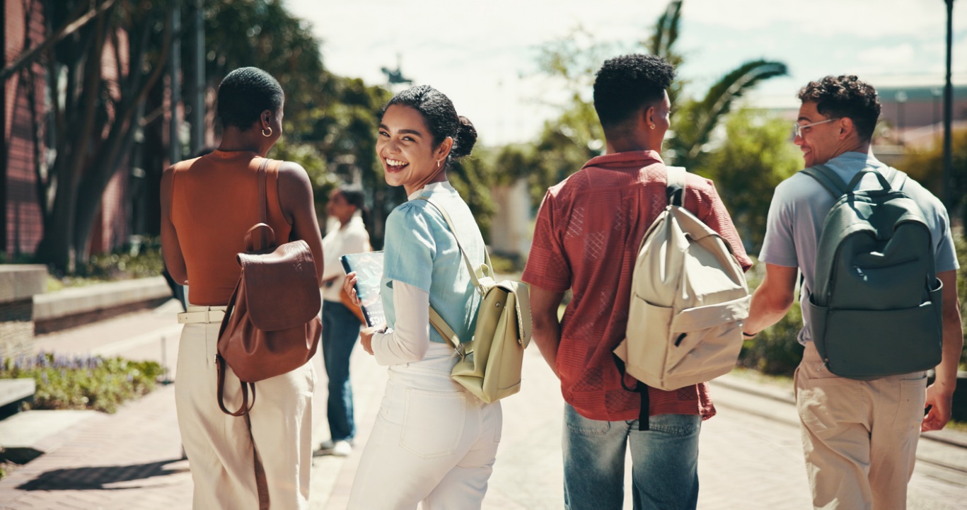 School-Friendly Orthodontic Options That Make Smiling at School Easier, A group of people with backpacks on, one person is turned backwards and smiling